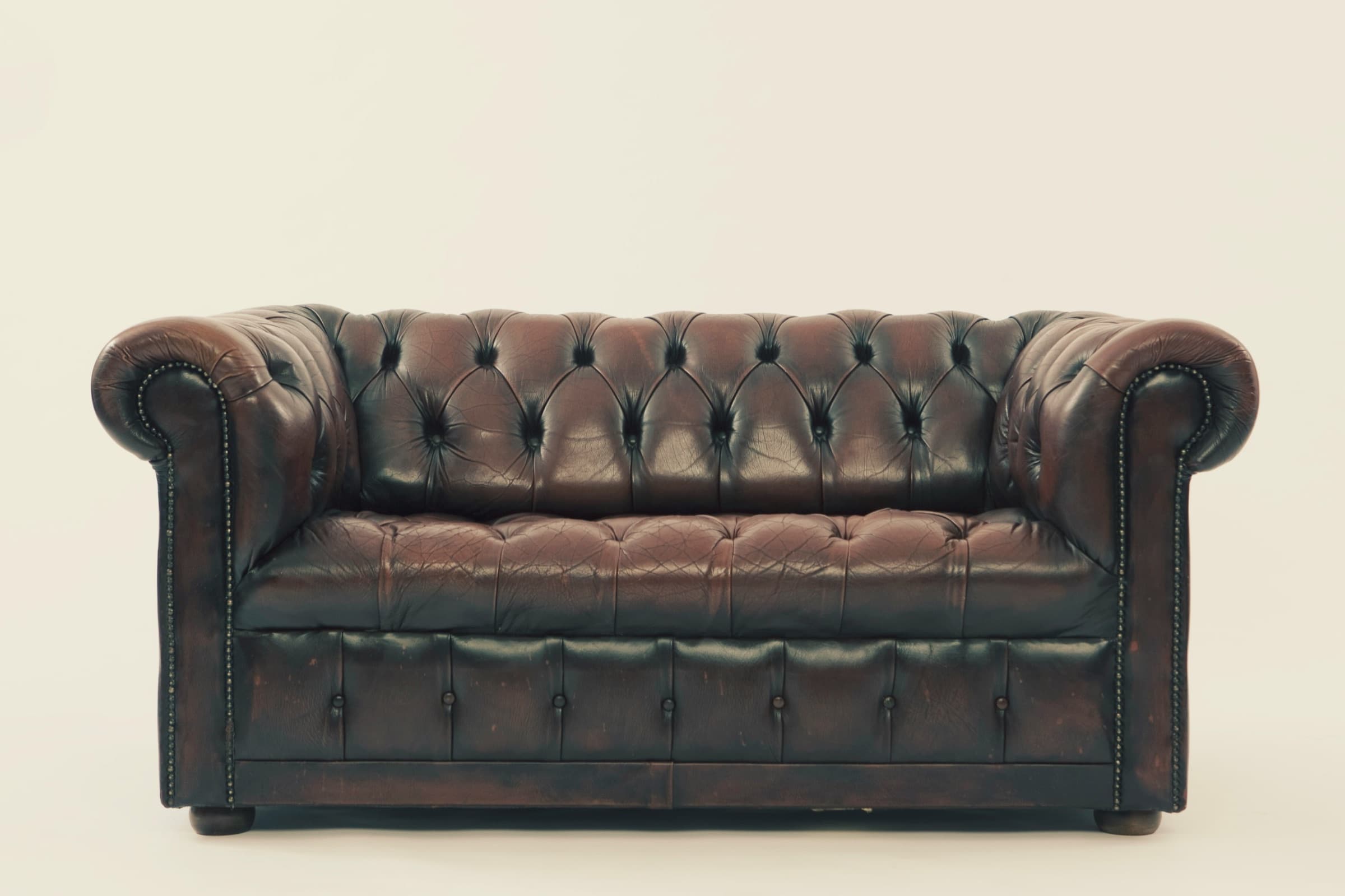 Timeless interior design: a well-worn leather Chesterfield sofa