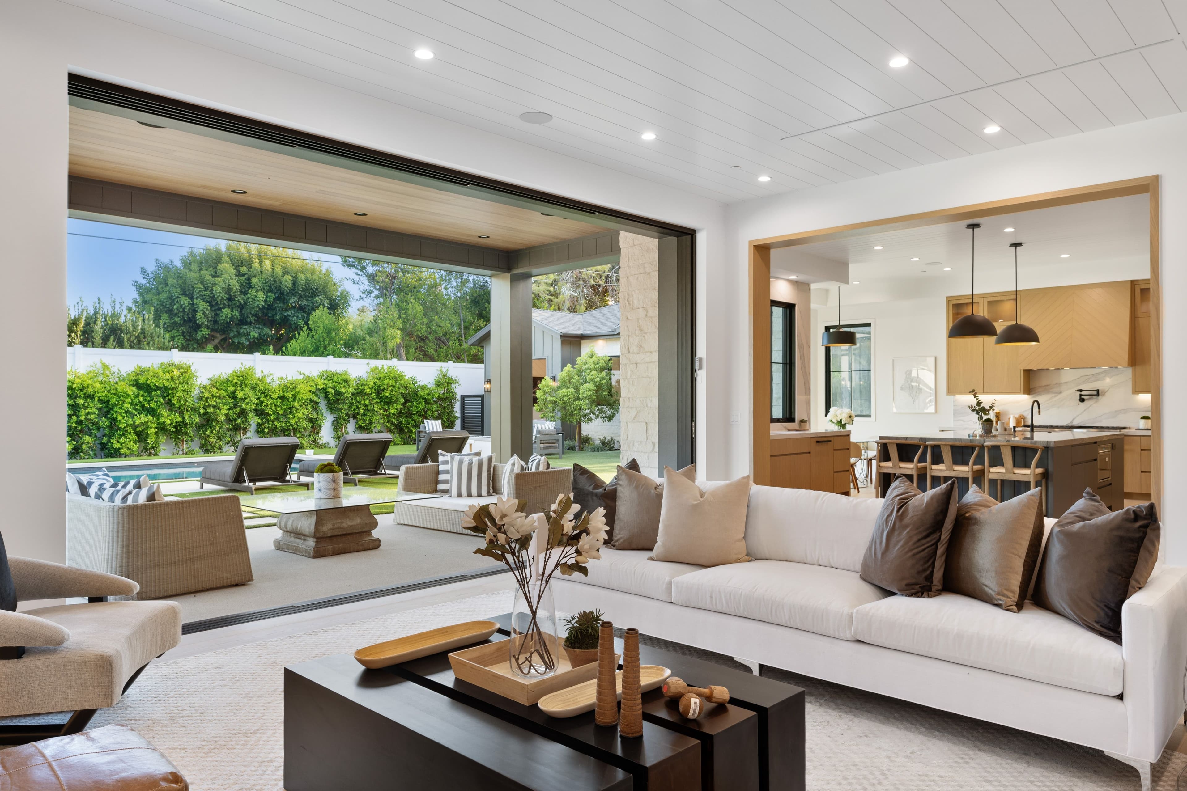 Interior design Sydney: indoor-outdoor living space opening onto a pool and garden