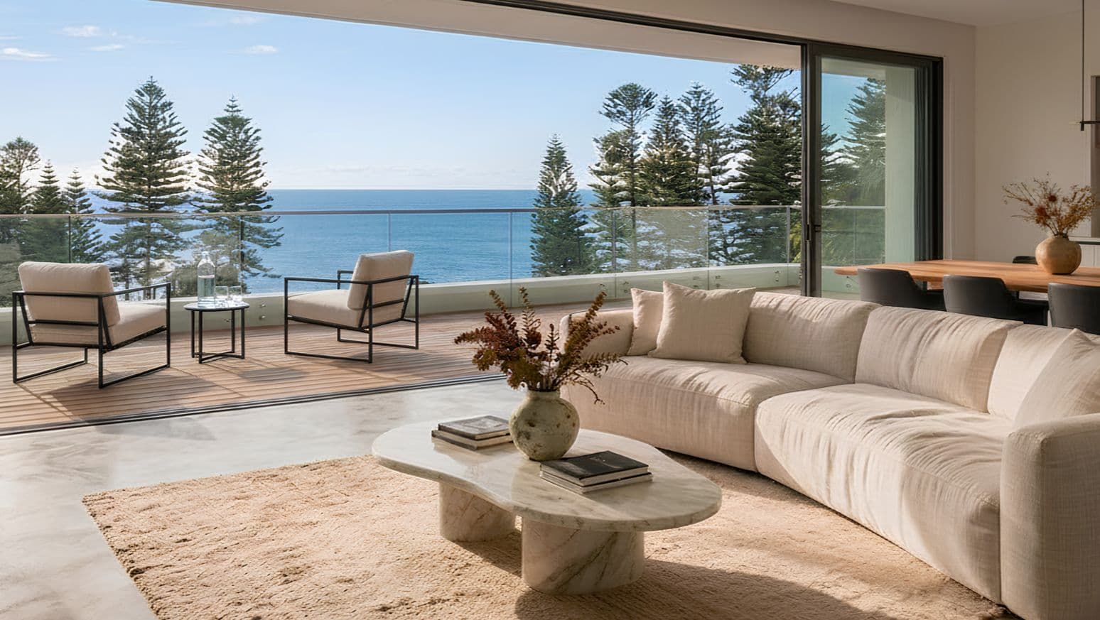Interior design Sydney: open-plan living in Manly opening onto a balcony with an ocean view